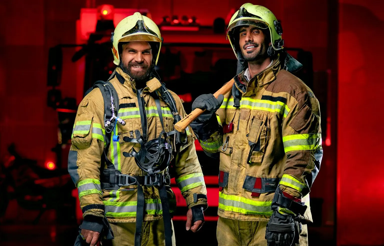 a couple of fire fighters standing next to each other